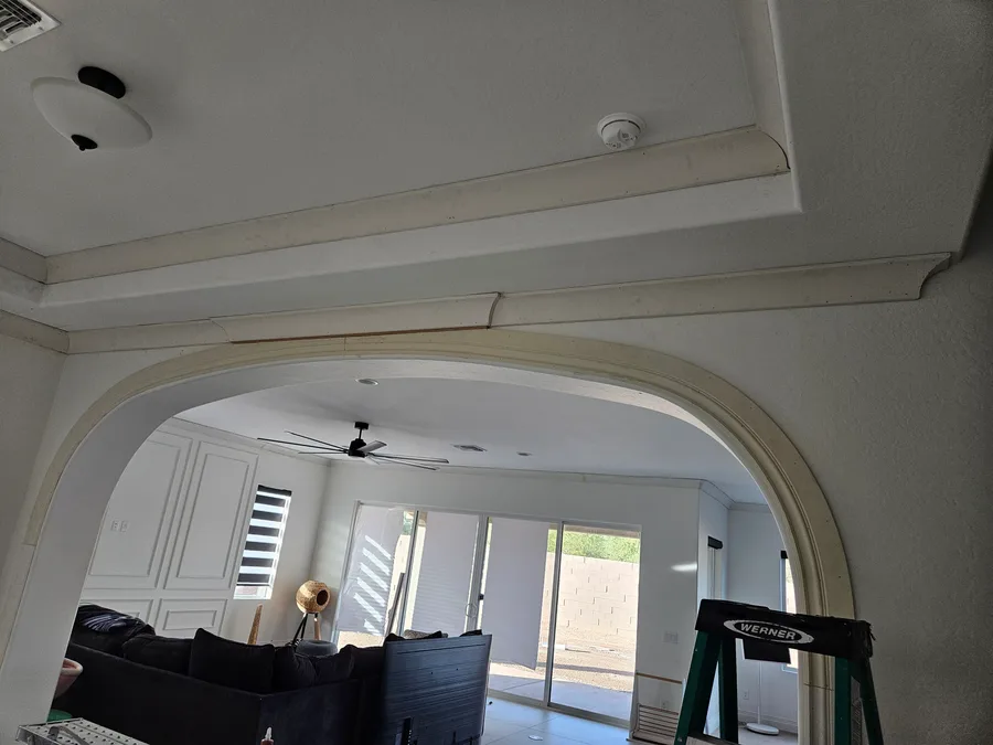 Cased arch opening with a coffered ceiling and crown molding, by Desert Forge Cabinets